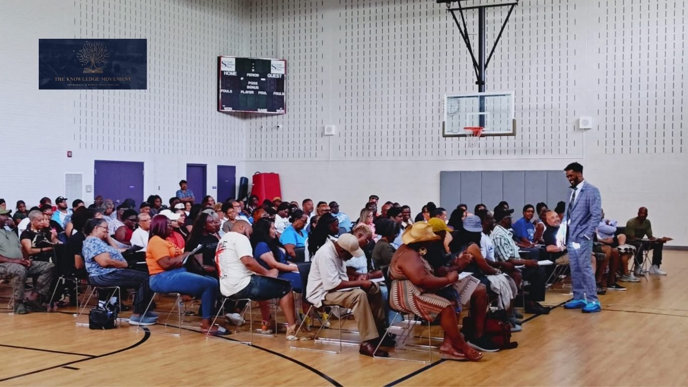 Mario A. Reed addressing a community gathering at a local gym